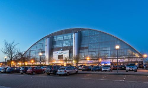 a large building with cars parked in a parking lot at MK SHORTSTAY DELUXE-Flat 2 in Milton Keynes