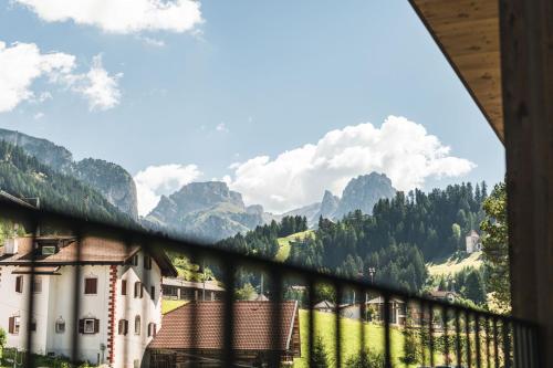 a view from the balcony of a house in the mountains at Amie Chalet in Santa Cristina in Val Gardena