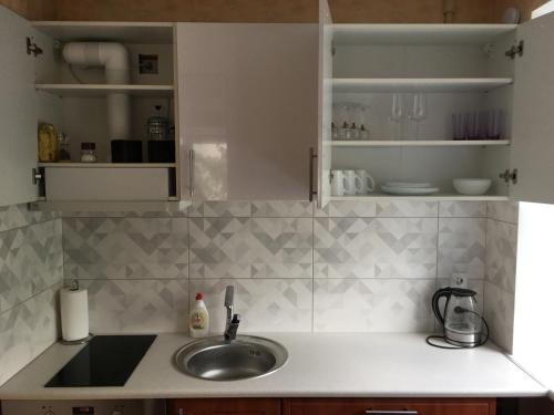 a kitchen with a sink and a counter top at Apartment near the seaside in Jūrmala