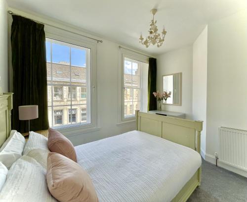 a bedroom with a large bed and a window at South Bridge Apartment in Edinburgh
