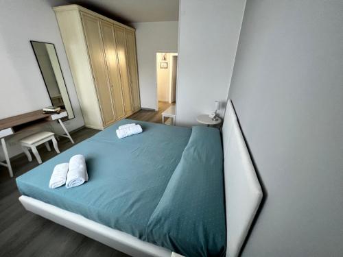 a bedroom with a bed with two white slippers on it at Interno1 in Mestre