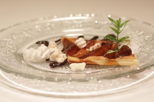 a plate with a dessert on a glass plate at Hotel-Restaurant Le Mont Paisible, Crans-Montana in Crans-Montana
