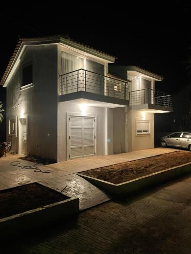 a house at night with a car parked in front of it at Swim on a private beach in Sounio