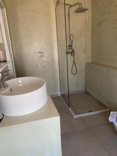a bathroom with a shower and a sink and a tub at Perland Vacation in Sidari