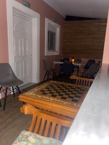 a living room with a chess board on a table at Perland Vacation in Sidari