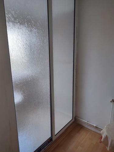 two sliding glass doors in a room with a wooden floor at Hostel EMY Camere cu baie proprie aproape de plaja 3 Papuci in Constanţa