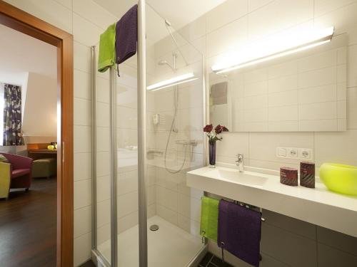 a bathroom with a sink and a shower at Hotel Am Turm in Kaufbeuren
