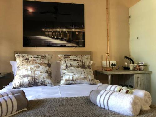 a bedroom with a bed with a large picture on the wall at The Bachelor Private Guest Room in Fernglen