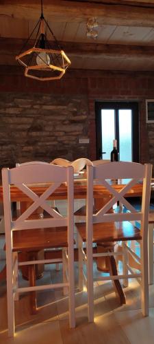 a dining room table with chairs and a chandelier at Etno kuća Ostrvica in Varnice