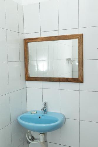 a bathroom with a blue sink and a mirror at BrightMoon_Homestay in Puducherry