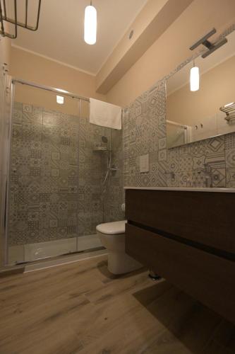 a bathroom with a sink and a toilet and a shower at ALMA B&B Home Cosenza in Cosenza
