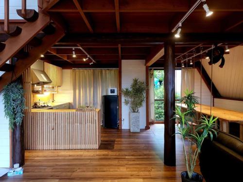 a room with a kitchen and a hallway with plants at LOGIN OKINAWA -plants- in Onna