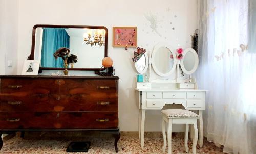 a dressing room with a dresser and a mirror at Casetta Nonna Giacomina 1camera da letto e soggiorno con angolo cottura in Valderice