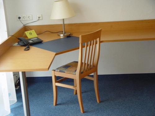 un bureau en bois avec une chaise et une lampe dans l'établissement Gasthof zur Sonne, à Stuttgart