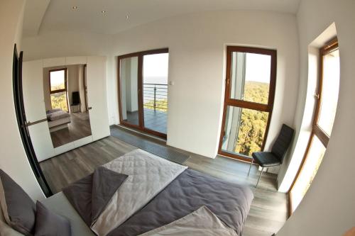 a bedroom with a bed and a view of the ocean at Baltic Apart in Dziwnówek