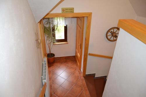 a hallway with a stairway with a plant in it at Chalupa 246 in Vrchlabí