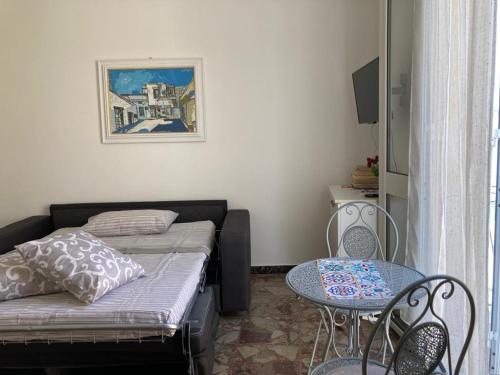 a small room with a bed and a table at La casina Salentina nido d'amore con vista mare in Parabita