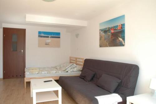 a living room with a couch and a bed at Apartamenty sopot-topos in Sopot