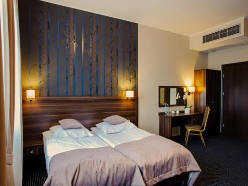 Postel nebo postele na pokoji v ubytování Hotel Sevilla