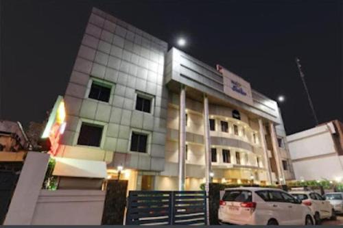 a building with cars parked in front of it at night at SHELTER HOTEL in Lucknow