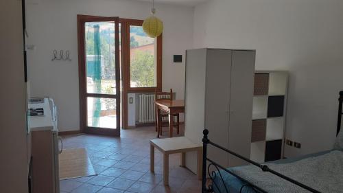 a room with a bed and a kitchen with a table at Ai Boschi in Ozzano dell'Emilia
