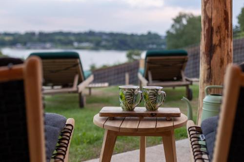 a table with two green cups on top of it at LAC ABANE AU LAC in Butgenbach