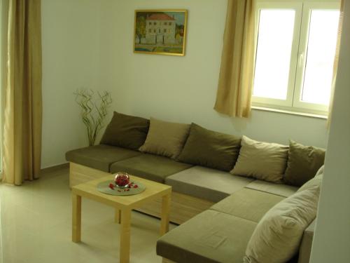 a living room with a couch and a table at Apartments Villa Danilovic in Herceg-Novi