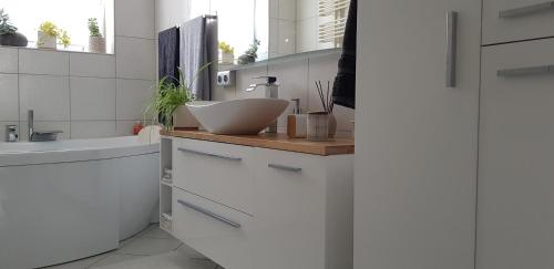 a white bathroom with a sink and a counter at Apartament I Love Gdynia in Gdynia