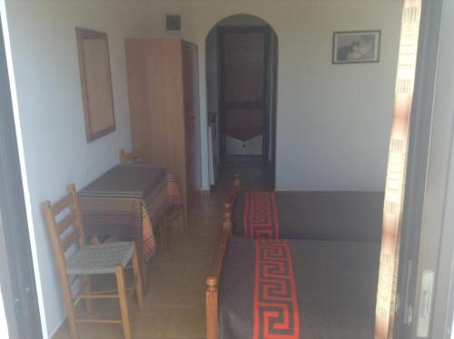a room with two tables and a table and chairs at Studio Stella in Plakias