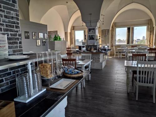 a restaurant with tables and chairs in a room at Oasis Park Hotel in Torre dell'Orso