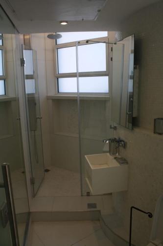 a bathroom with a shower and a sink and a window at The White House Jerusalem סוויטת הבית הלבן ירושלים in Jerusalem
