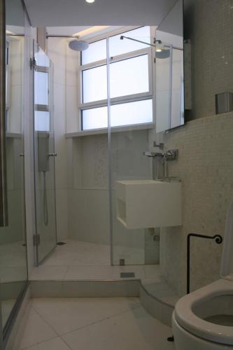 a bathroom with a shower and a toilet and a window at The White House Jerusalem סוויטת הבית הלבן ירושלים in Jerusalem