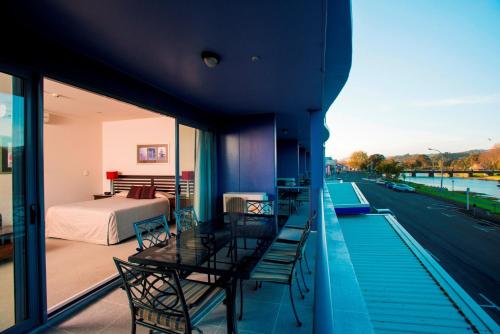 a balcony with a view of a bedroom and a bed at Emerald Hotel in Gisborne