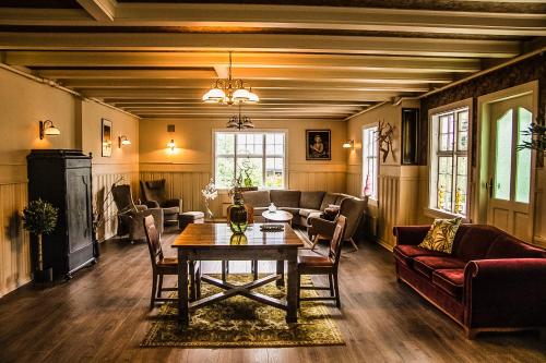 a living room with a table and a couch at Valldal Fjord Lodge B&B in Valldal