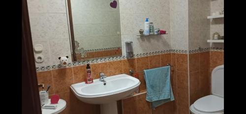 a bathroom with a sink and a toilet and a mirror at Apartment Monte Cristo in Casablanca