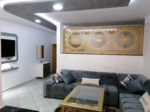 a living room with a couch and a table at Hébergement lux dakhla in Dakhla