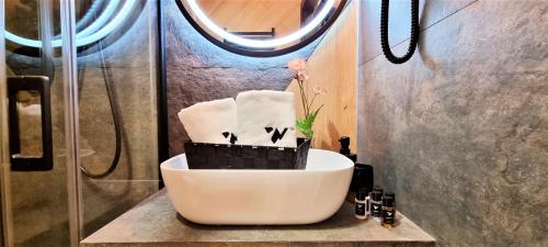 a bathroom with a white sink and a shower at Wrota Chałubińskiego in Zakopane