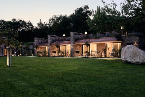a house with a lawn in front of it at Relais Rossar Boutique Hotel Garda & Hills in Costermano sul Garda