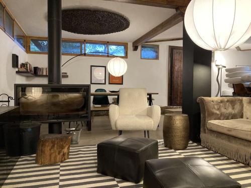 a living room with a couch a chair and a piano at La Amapola in Valdemorillo
