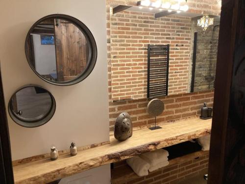 a bathroom with a counter with a mirror and a sink at La Amapola in Valdemorillo