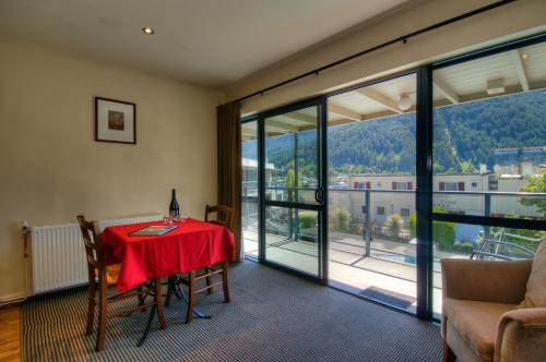 a room with a table with a red table cloth at Four Seasons Motel in Queenstown