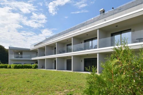an apartment building with a lawn in front of it at TI Hotel in Rogaška Slatina