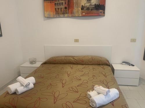 a bedroom with a bed with two towels on it at HOTEL LABRADOR in Cattolica