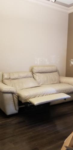 a white couch sitting in a living room at Parson Creek Cozy suite in Fort McMurray