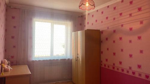 a room with a window and pink hearts on the wall at Doctor's House in Gyumri