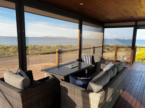 a living room with a table and chairs on a balcony at Lincoln View Holiday House in North Shields