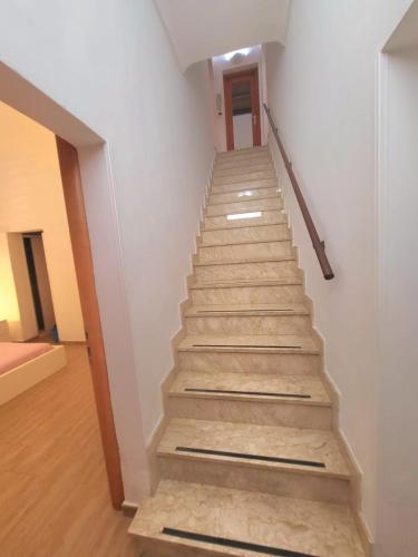 a staircase in a building with wooden floors and white walls at La Perla Di Noto in Noto