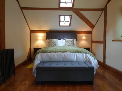 a bedroom with a bed with a blue bench in it at Sans, Souci. @ Mill House in Horncastle