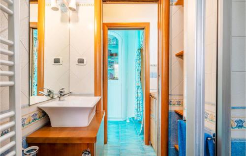 a bathroom with a sink and a mirror at Nice Home In Gaeta With Kitchen in Gaeta