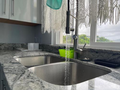 un lavello da cucina con acqua che ne esce di Hilltop Condos a Gros Islet